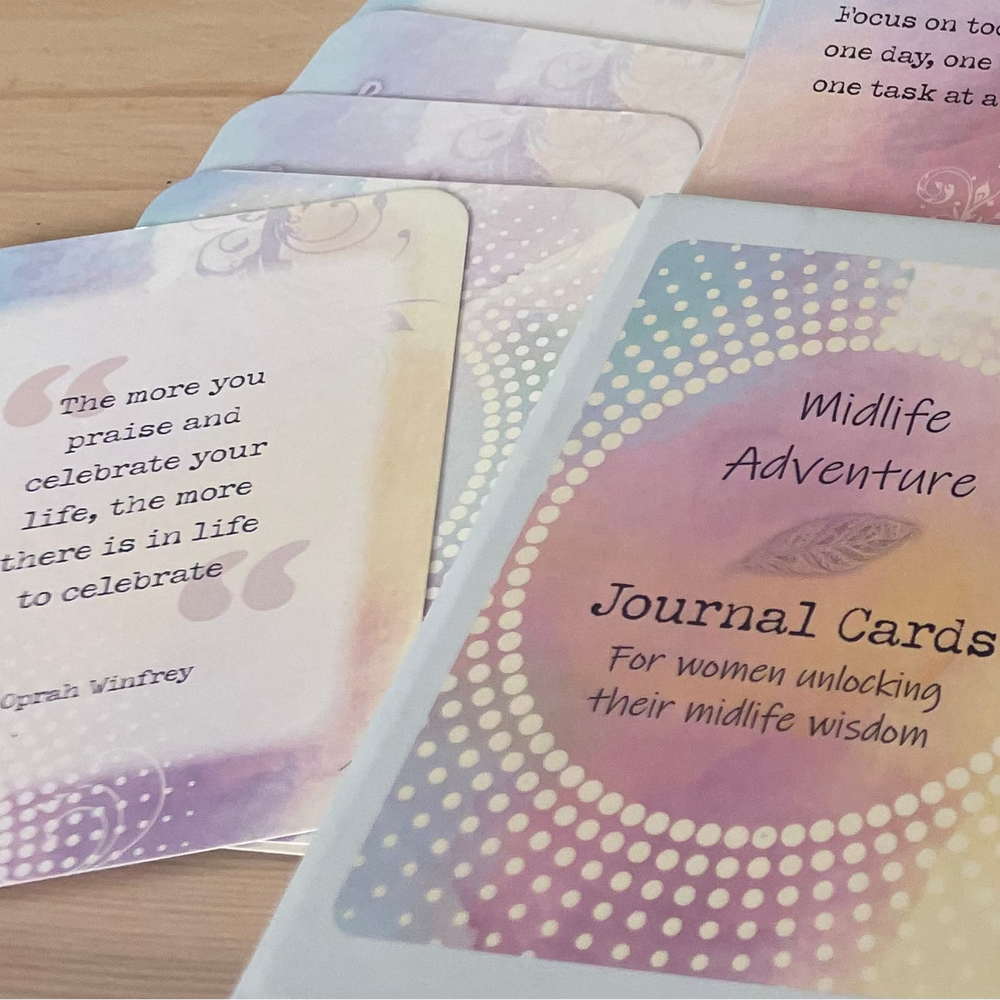 Set of journal cards with colorful designs and text on a wooden surface.