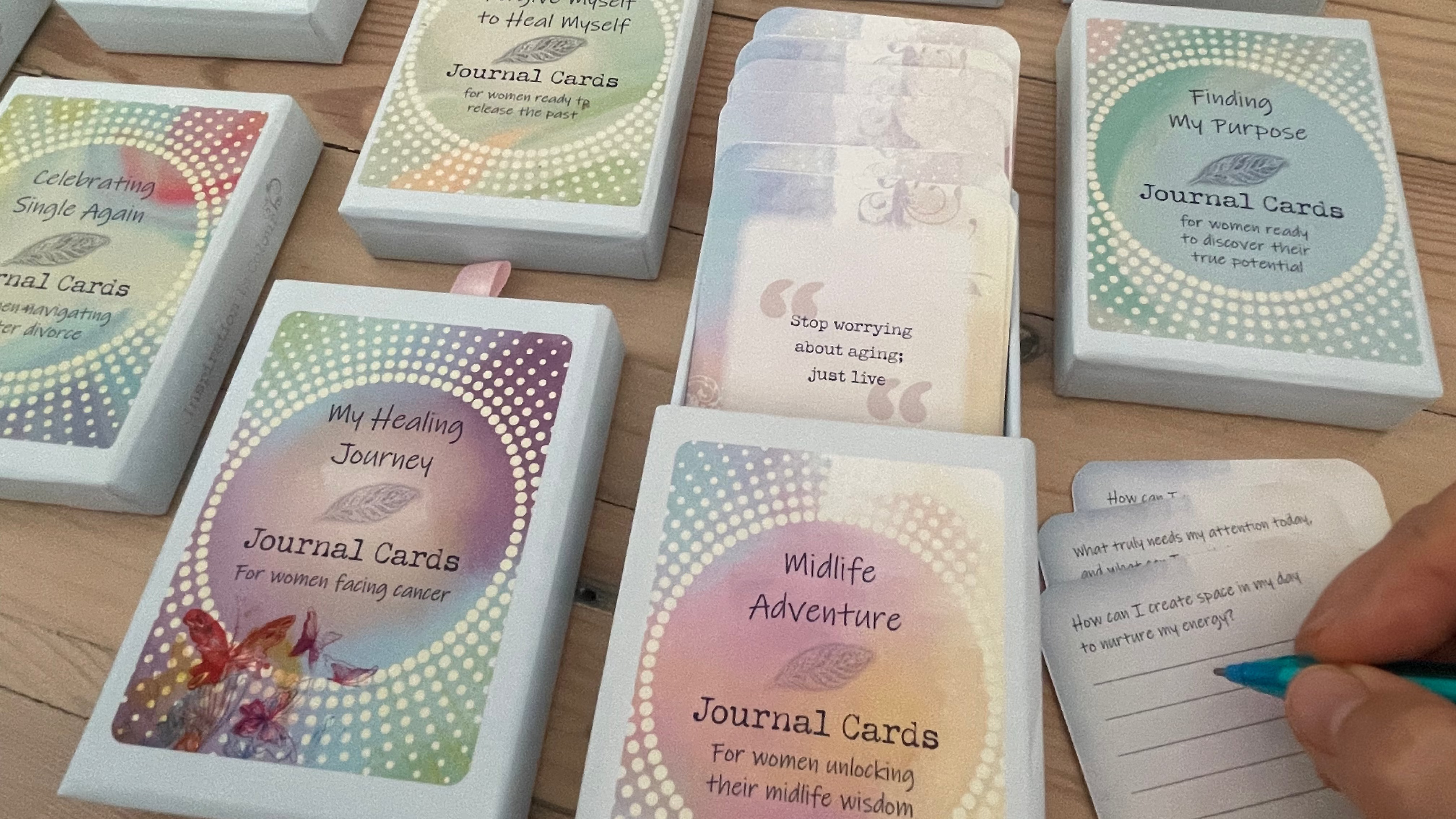 Collection of journal cards in various designs on a wooden surface.