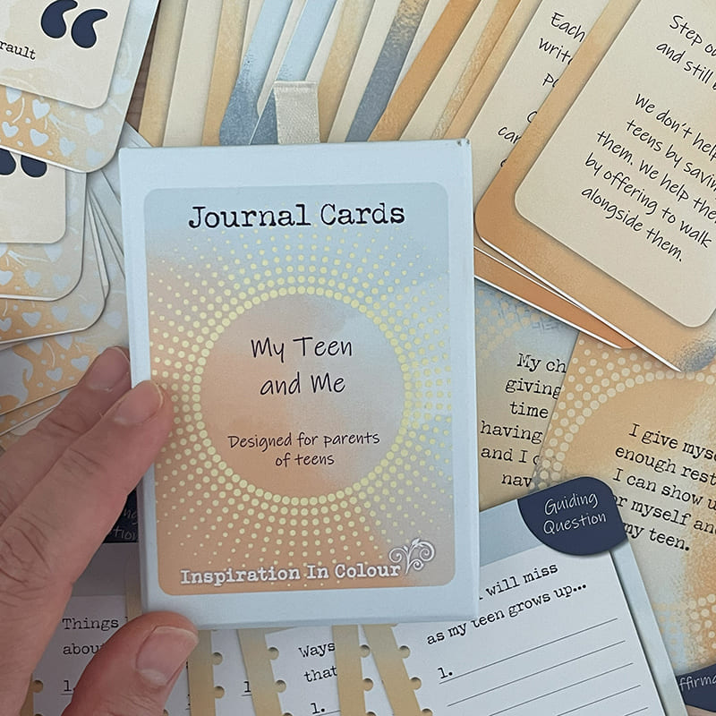 My Teen and Me Journal Cards – deck for parents of teens, boxed set held in hand with guiding question and affirmation cards visible in the background.
